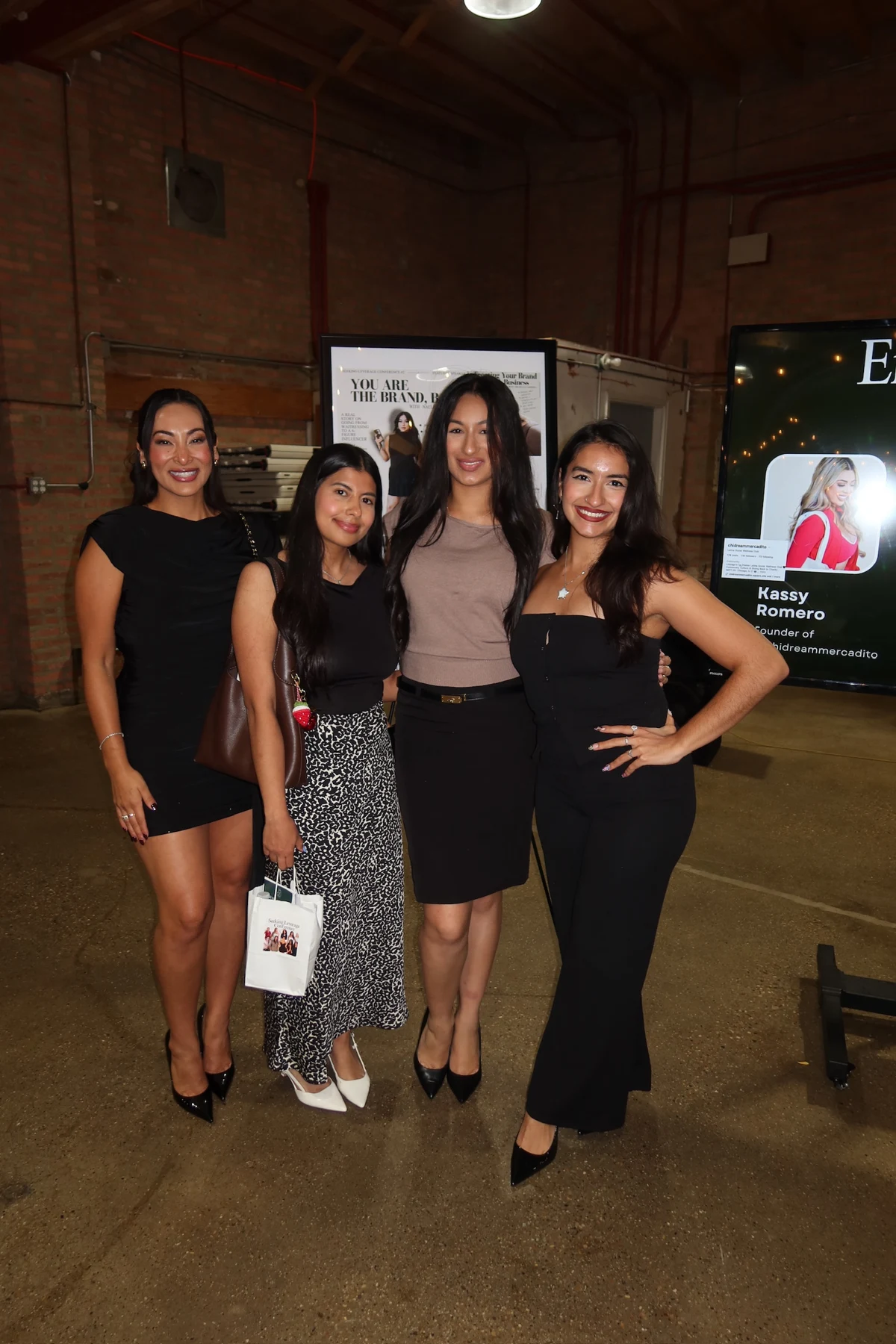 Four community members posing together at the conference